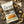 Load image into Gallery viewer, A bag of EPIC Provisions' Sea Salt and Pepper Pork Rinds laying on a rustic wooden table. Next to the bag of pork rinds is actual pork rinds, sea salt, and pepper.
