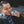 Load image into Gallery viewer, A man eating a bit of an EPIC Grass-fed Vension Sea Salt Pepper Bar outside.
